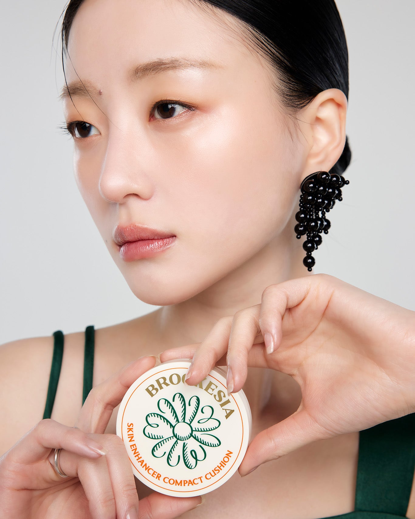 Model showcasing Brookesia Skin Enhancer Compact Cushion (Glow) 